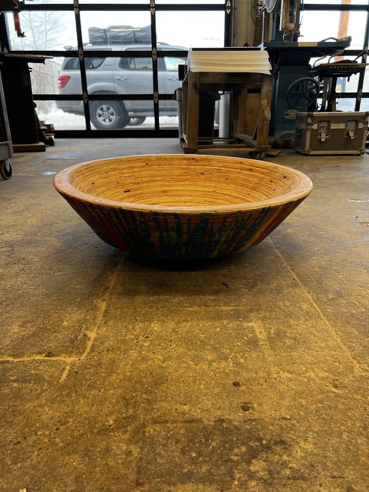 A finished turned wooden bowl on a workbench