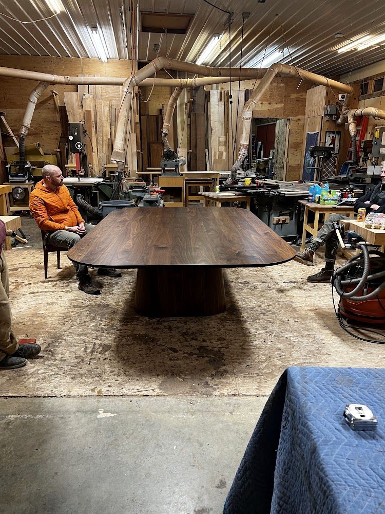 A large wooden table in a member's workshop