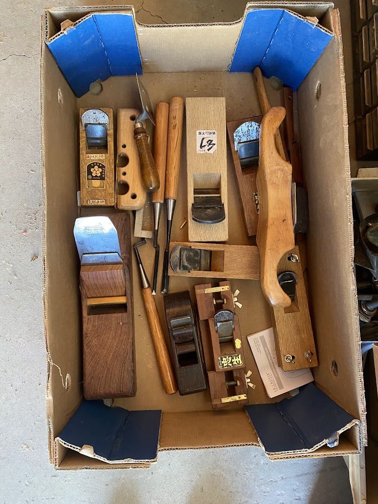 A box of vintage wooden hand planes